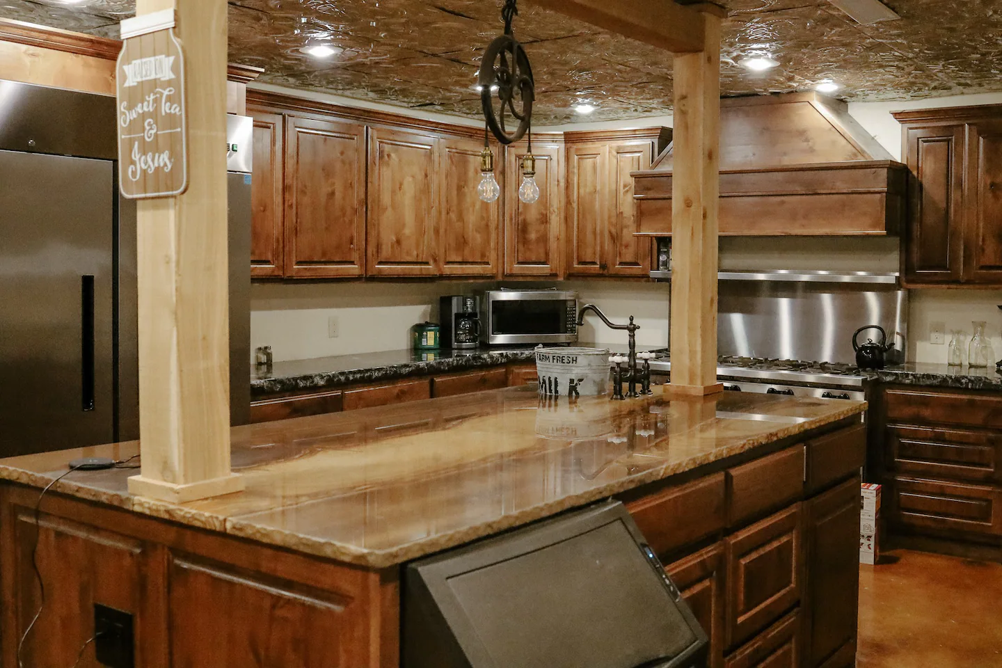 spacious kitchen with large island and dark wooden cabinets