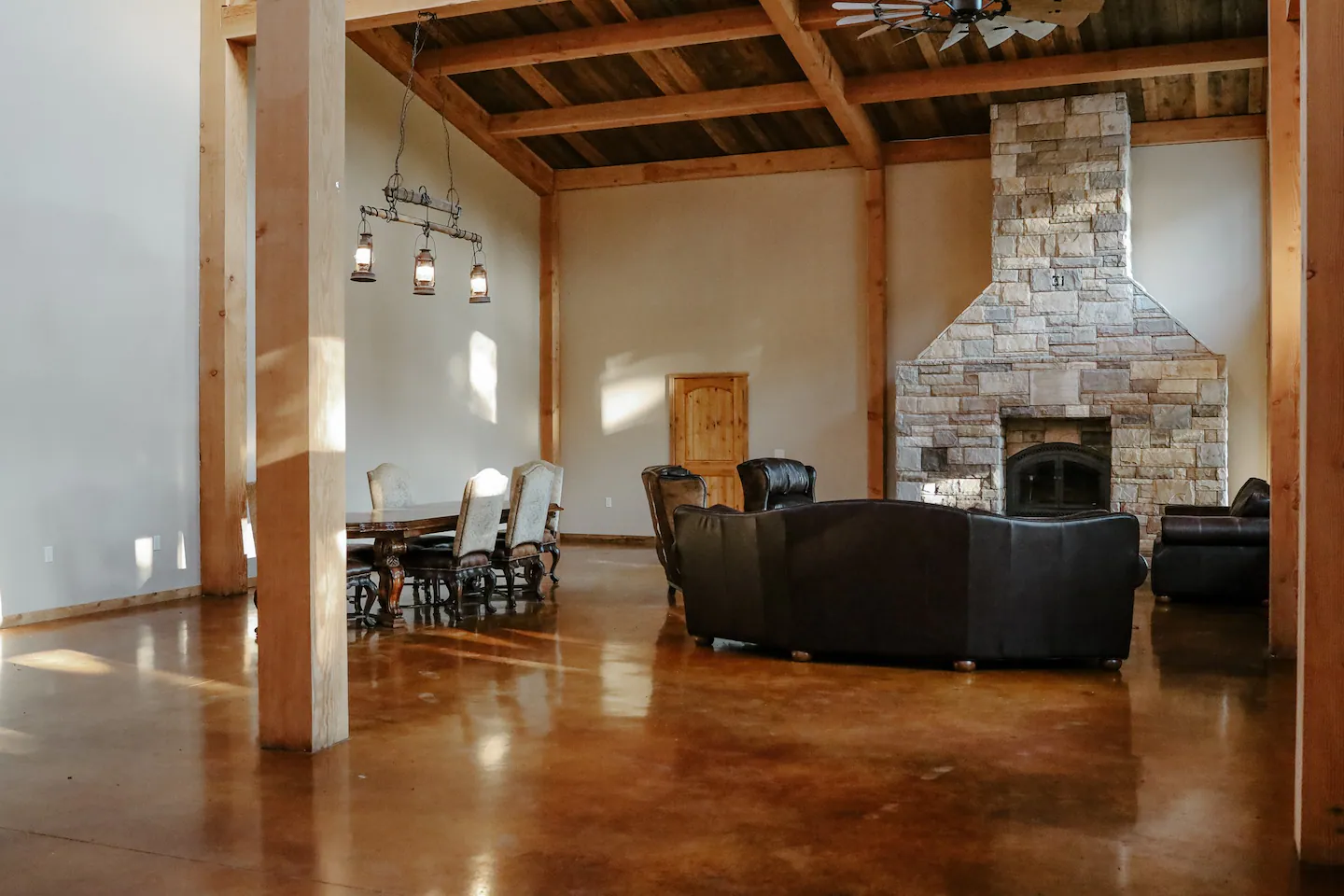 open living room and dining room with large stone fireplace