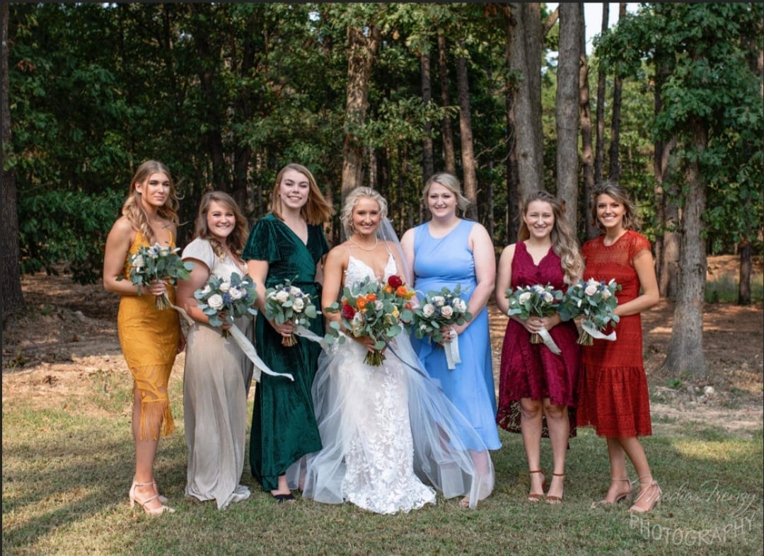 bride and bridesmaids in multicolor fall dresses