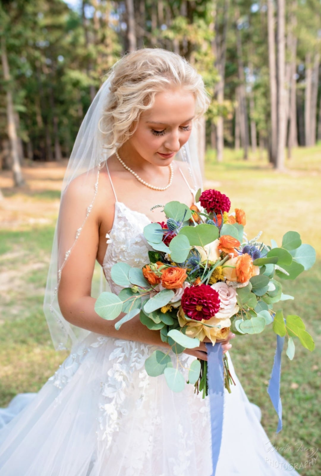 bride holding colorful bridal bouquet