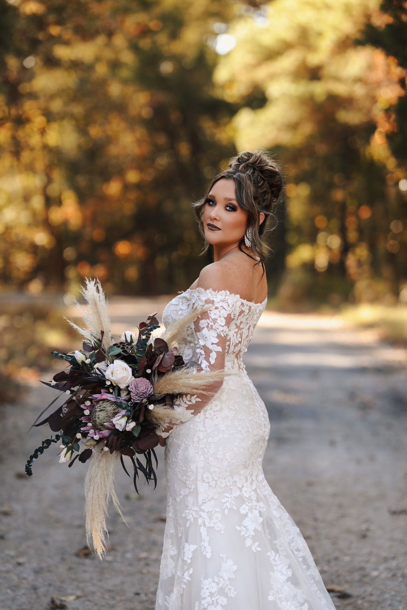 bride looking over her shoulder holding bridal bouquet