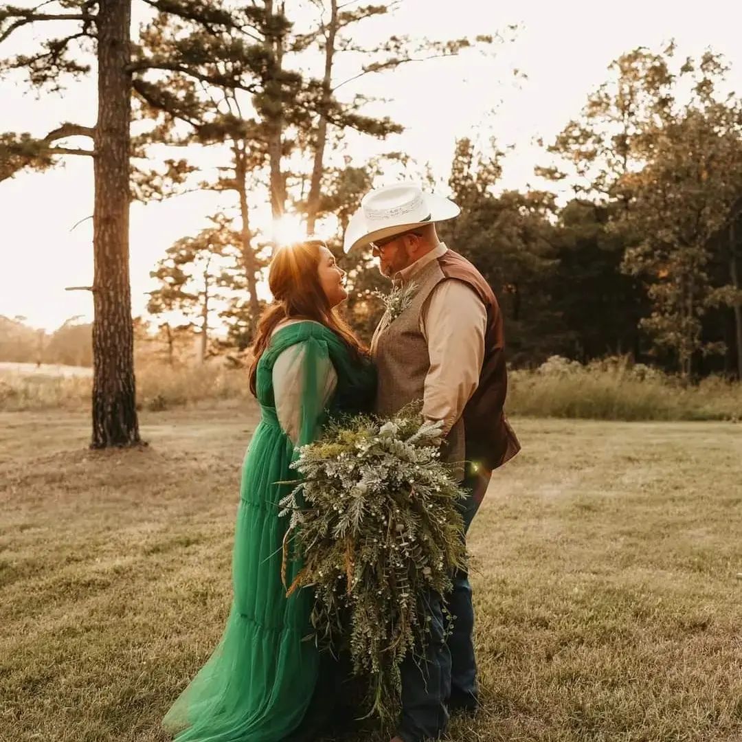 bride and groom standing together at sunset
