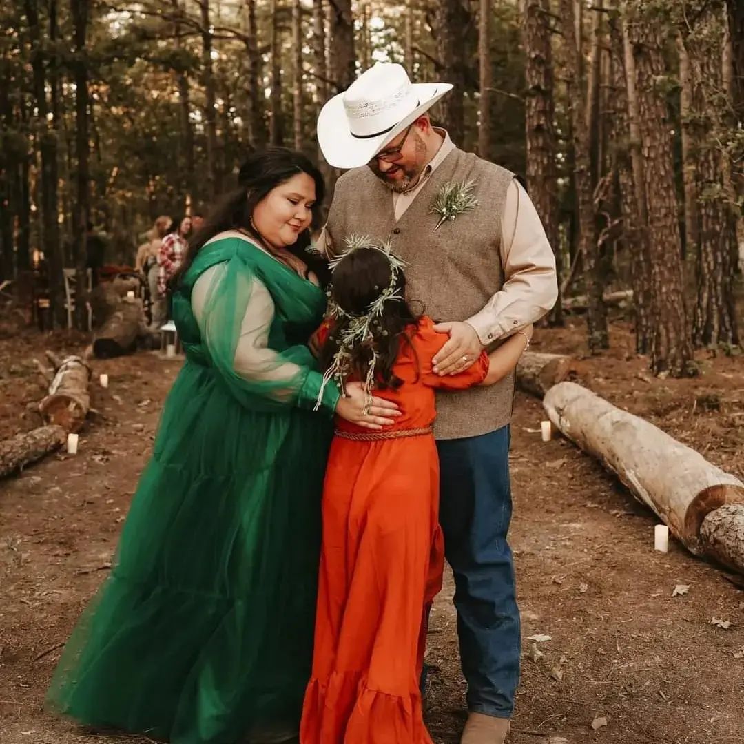couple hugging daughter