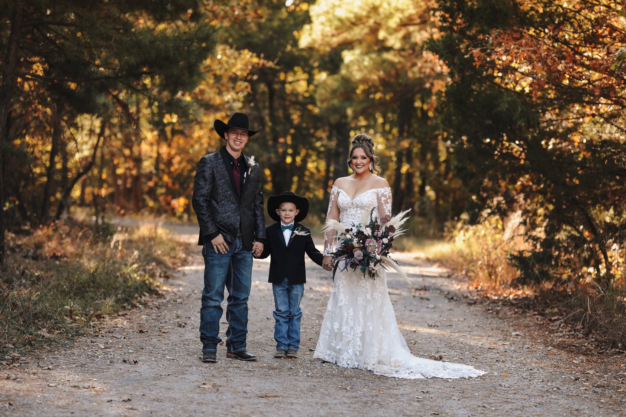 bride and groom holding hands with their son