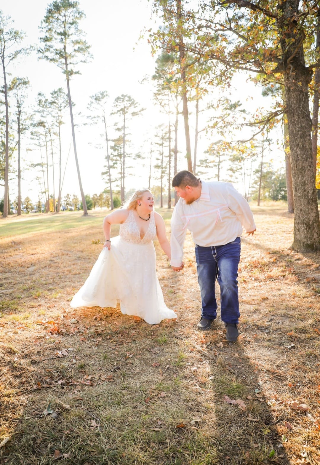 bride and groom holding hands and laughing
