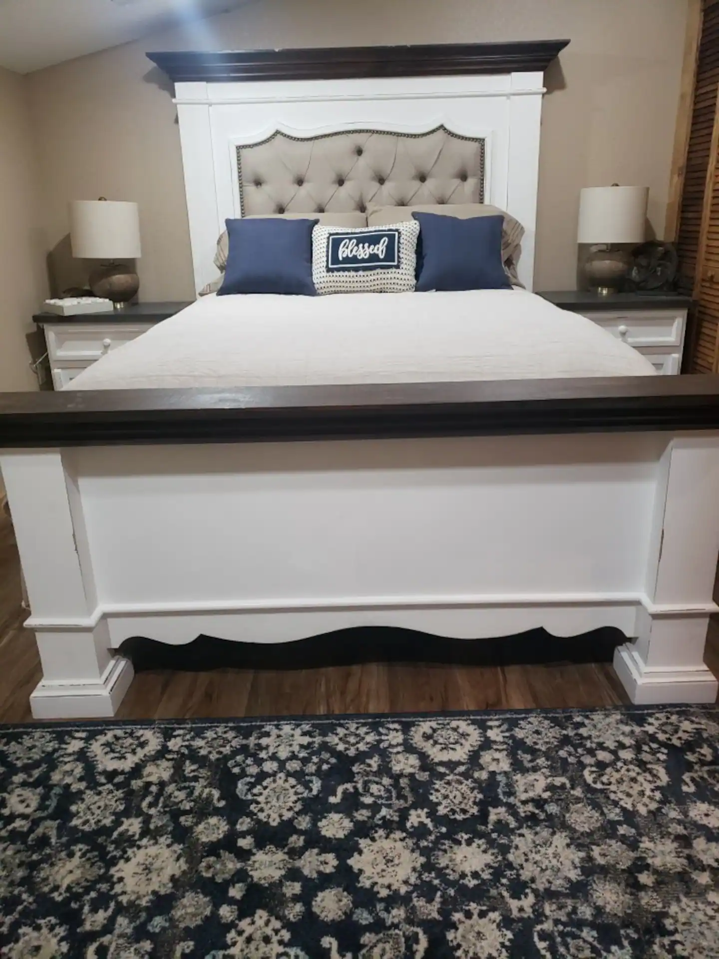 king sized bed with wooden footboard and headboard