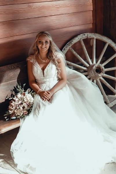 bride sitting on antique church pew