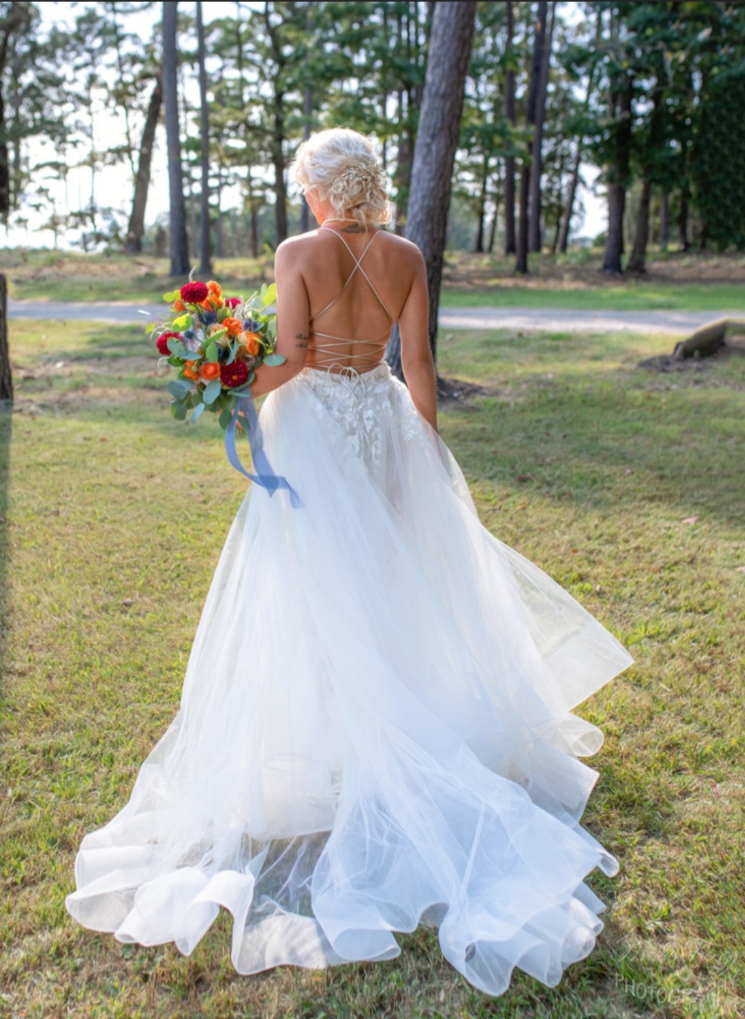 bride in flowy lace gown with lace up back