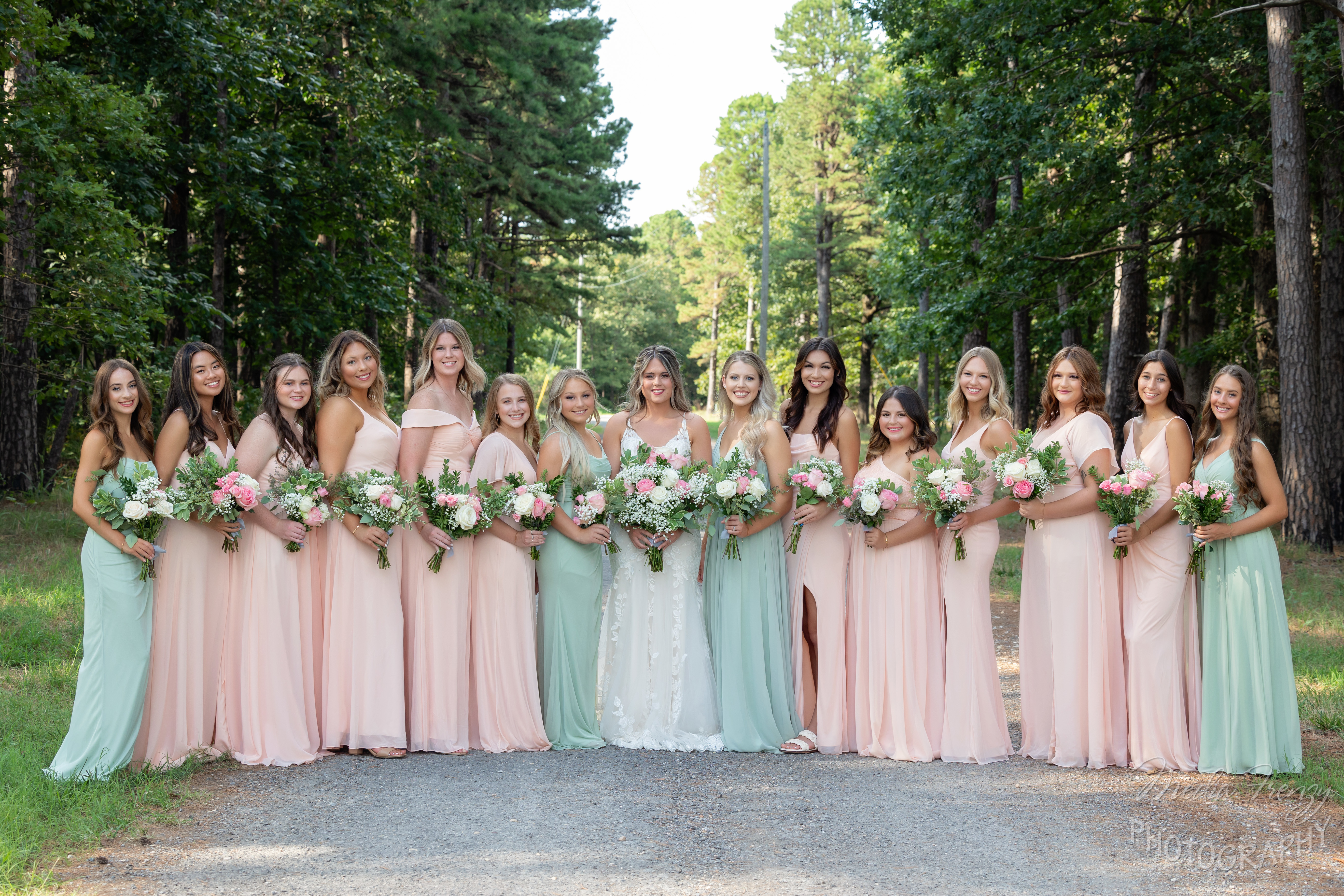 bride and bridesmaids in pastel pink and green dresses